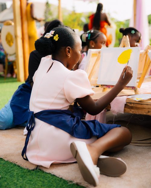 Free Young children enjoy painting in an outdoor art class in a park setting. Stock Photo