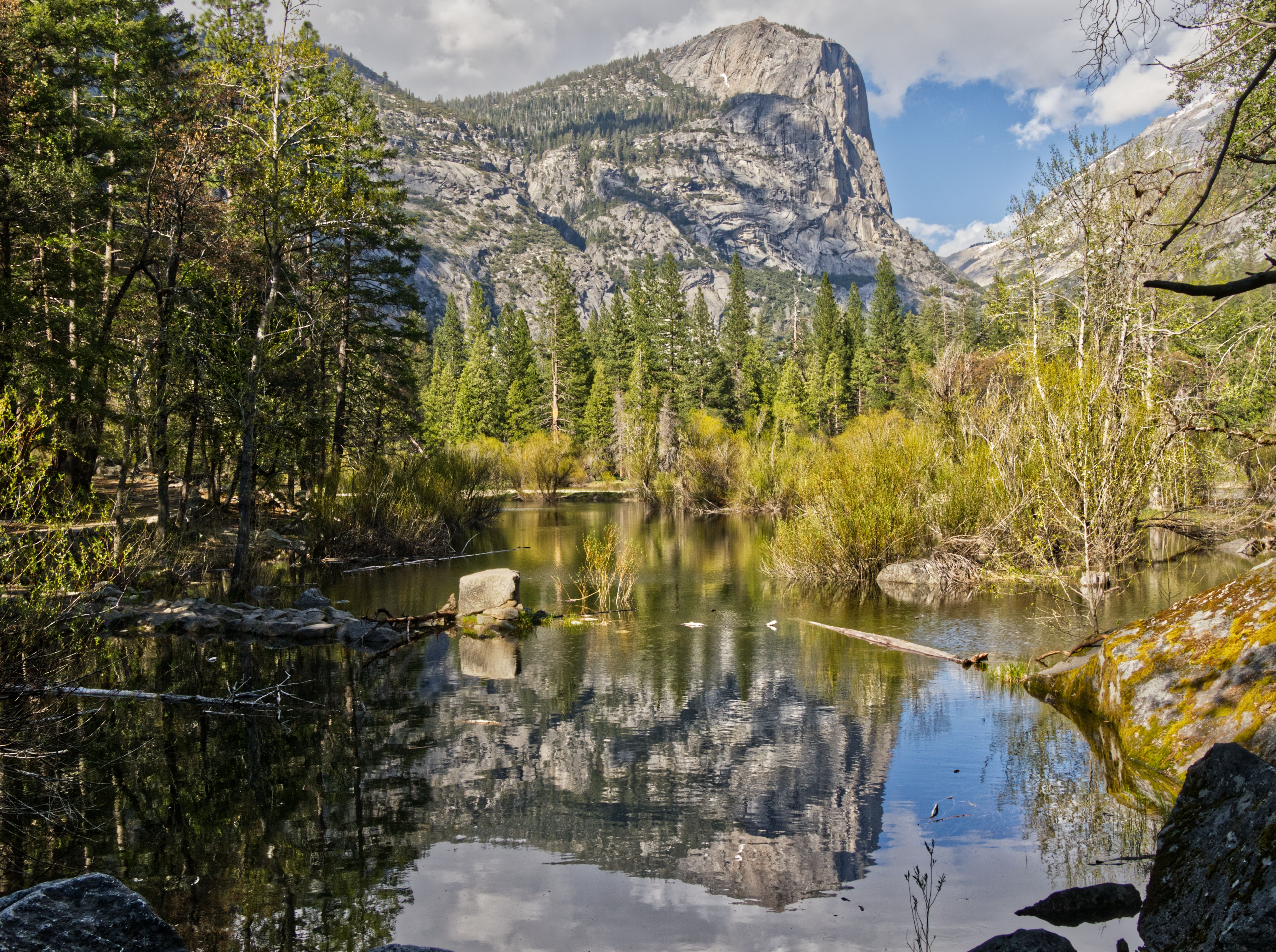 Tranquil view of a lake with mountain reflections in Yosemite National Park, California.