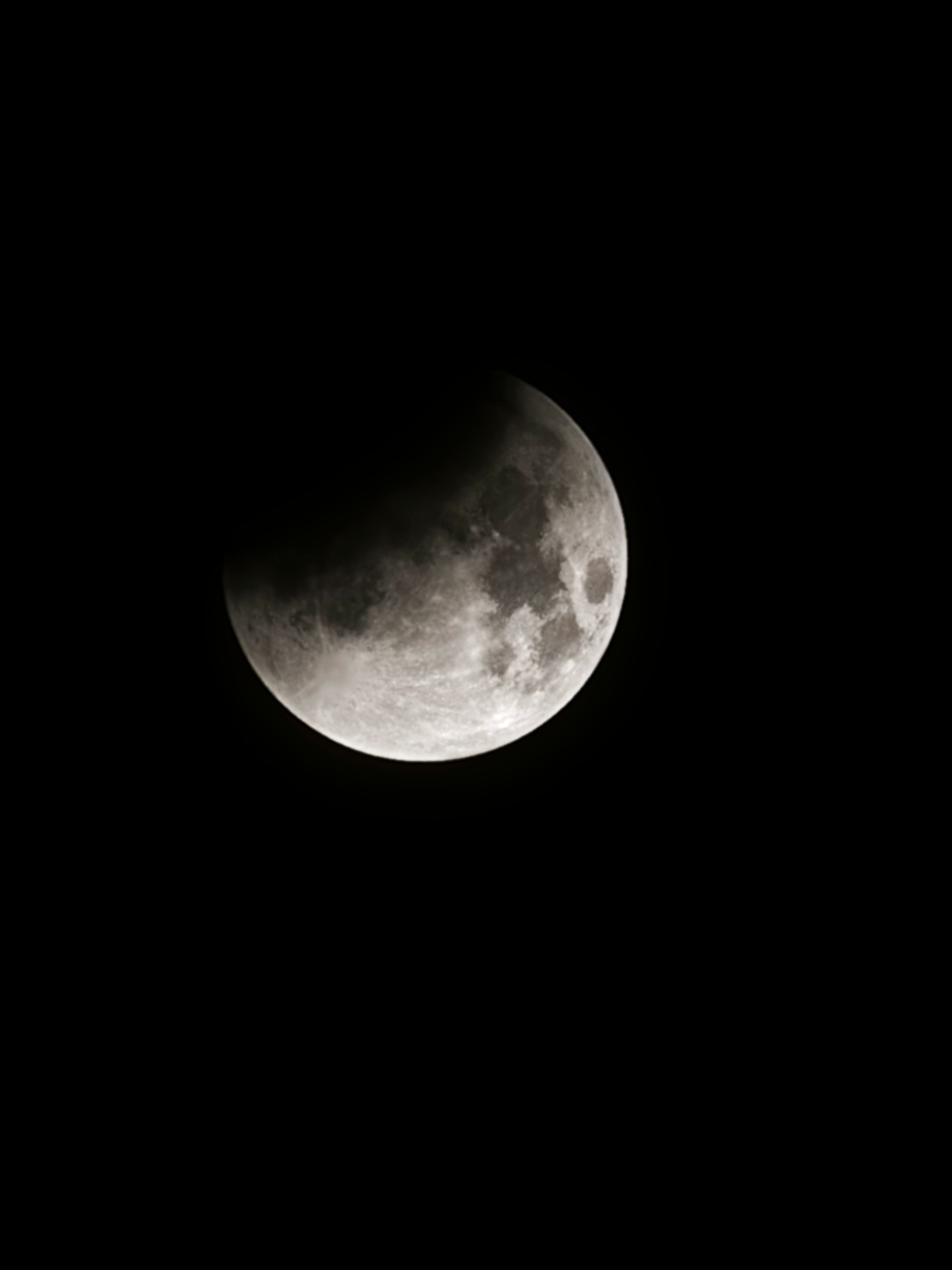 A captivating view of a partial lunar eclipse on a clear night sky.