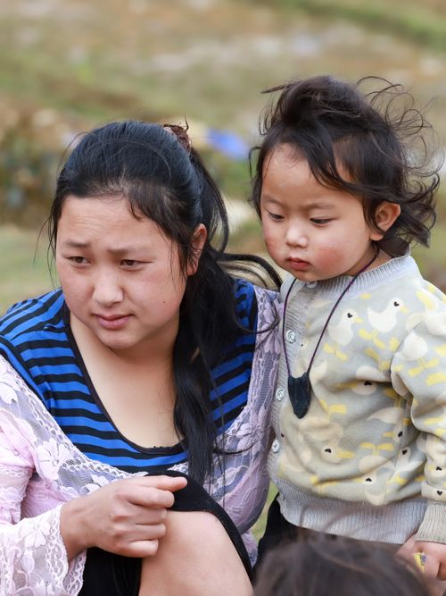 Free A heartfelt moment captured between a mother and her child in the natural setting of Lào Cai, Vietnam. Stock Photo