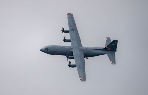 Free USAF Lockheed C-130 Hercules performing a flyover at Huntington Beach Airshow. Stock Photo