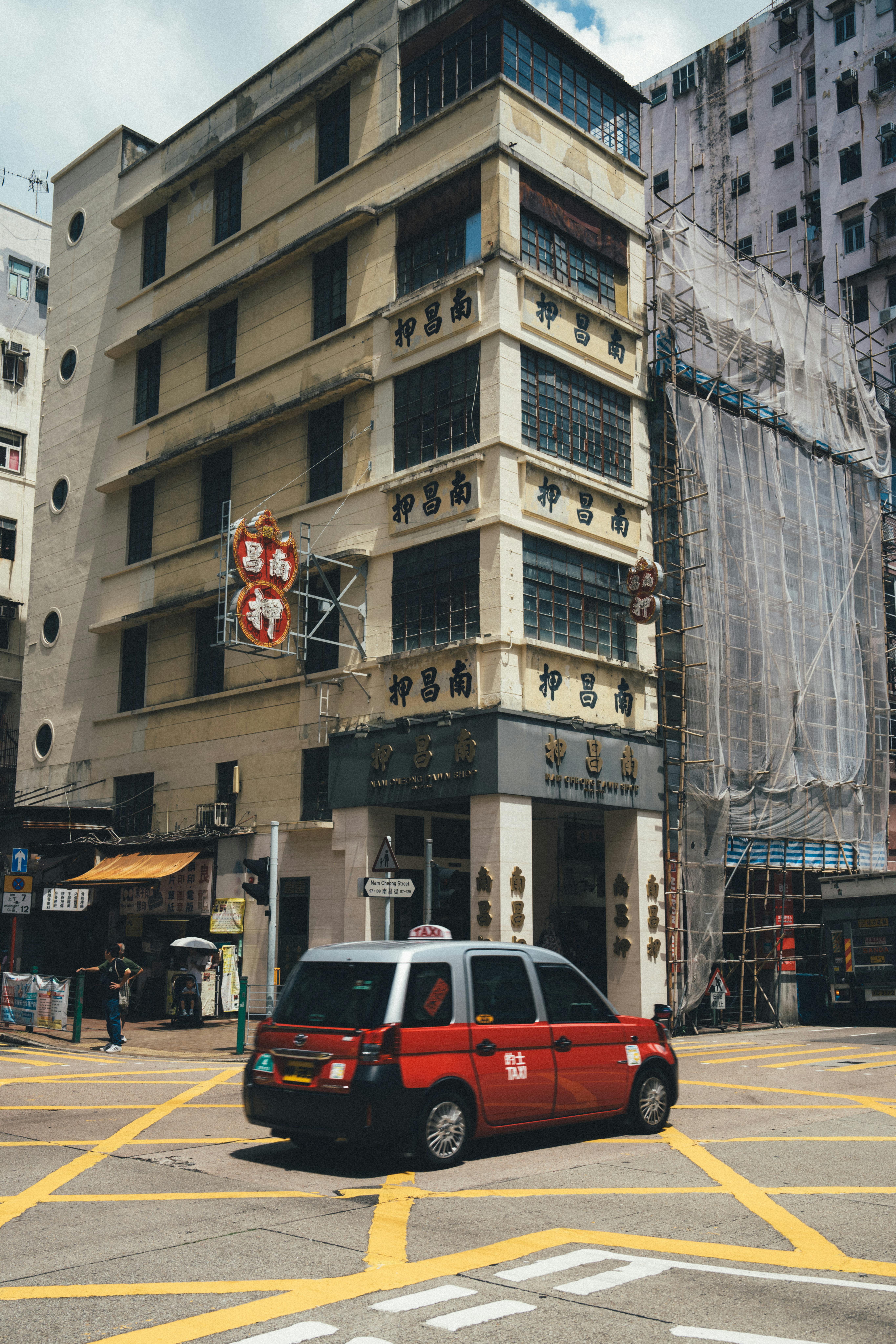 Free Vibrant urban street view featuring a taxi and historic architecture in Hong Kong. Stock Photo