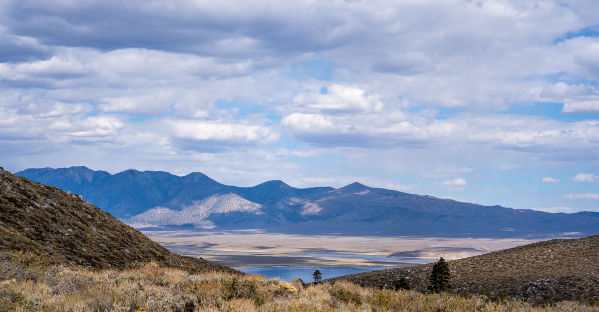 Breathtaking view of mountains and lake under a cloudy sky at Mammoth Lakes, California.