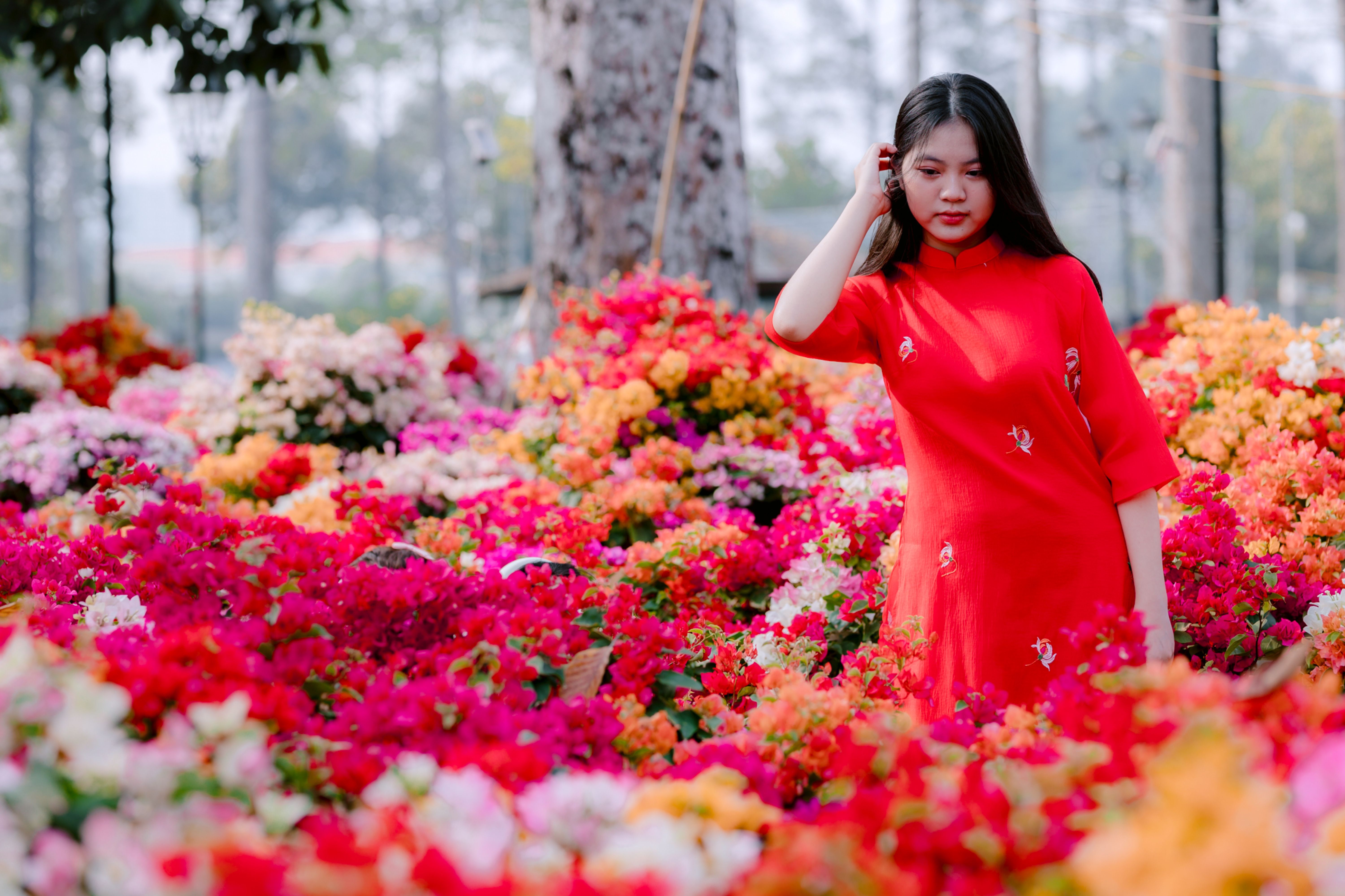 Young Woman in Red Dress Amidst Vibrant Flowers · Free Stock Photo