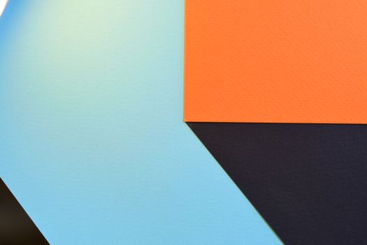 Abstract geometric design featuring bold blue, orange, and black shapes.