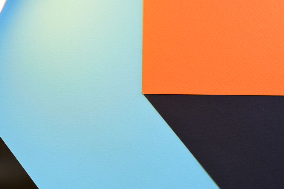 Abstract geometric design featuring bold blue, orange, and black shapes.
