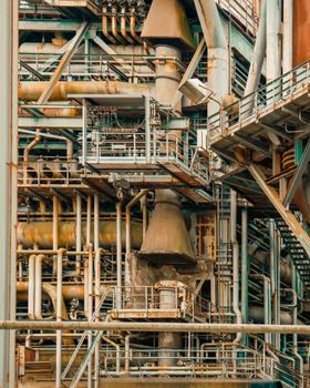 Detailed view of a complex industrial structure with rusted pipes and machinery in Duisburg, Germany.