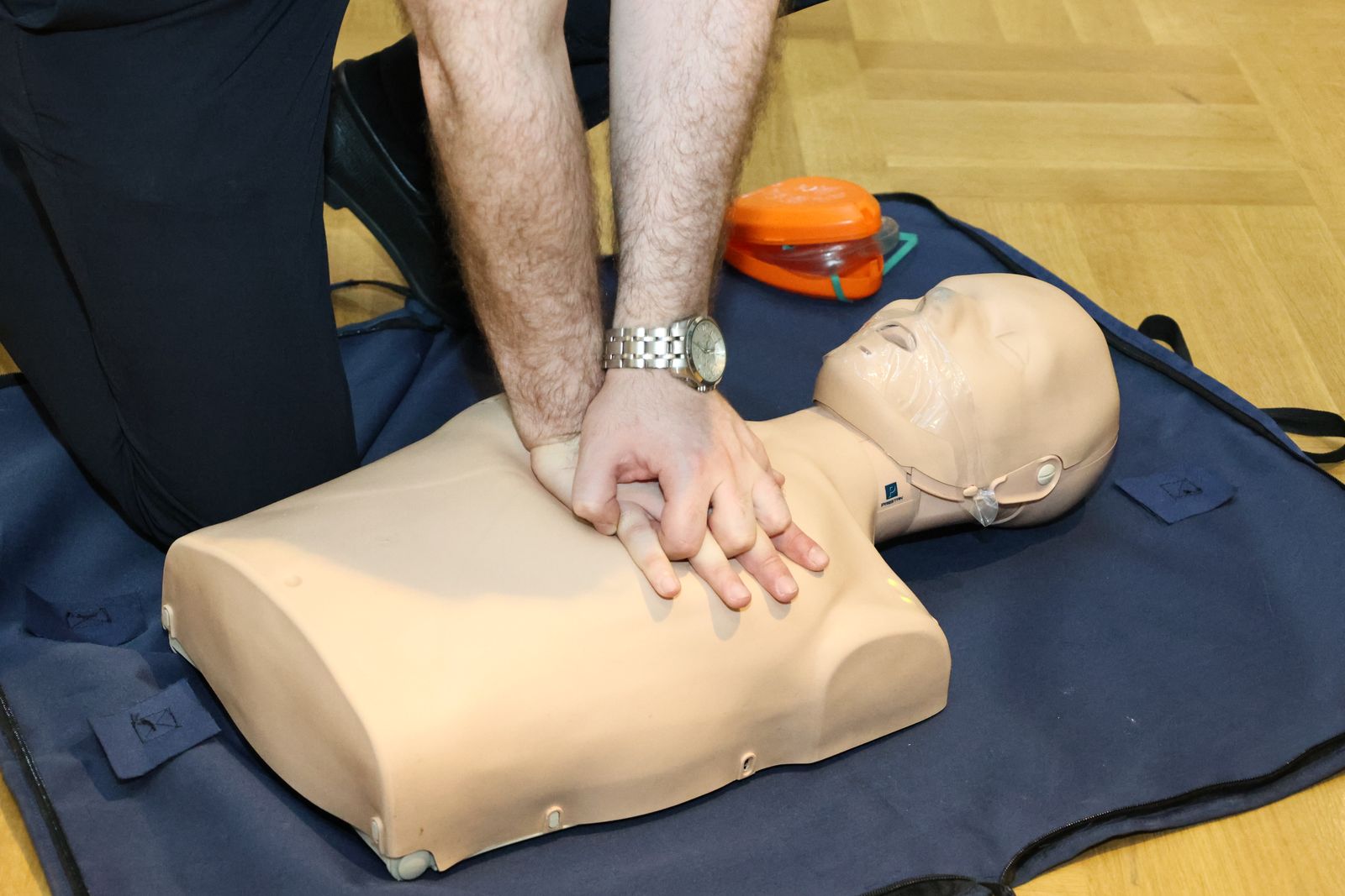 Hands practicing a resuscitation technique on a training mannequin