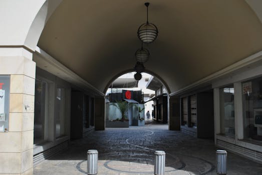 Elegant shopping arcade showcasing arched design and ambient lighting with 50% sale signs.