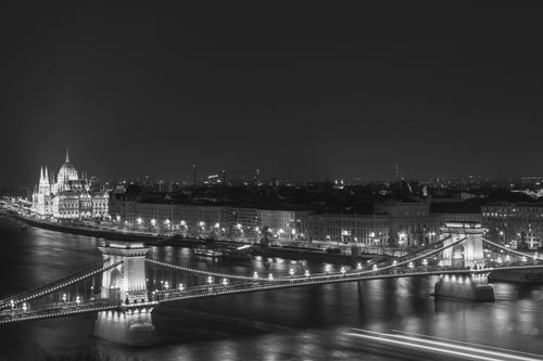 Free A captivating black and white nighttime view of Budapest featuring the Chain Bridge and Parliament Building. Stock Photo