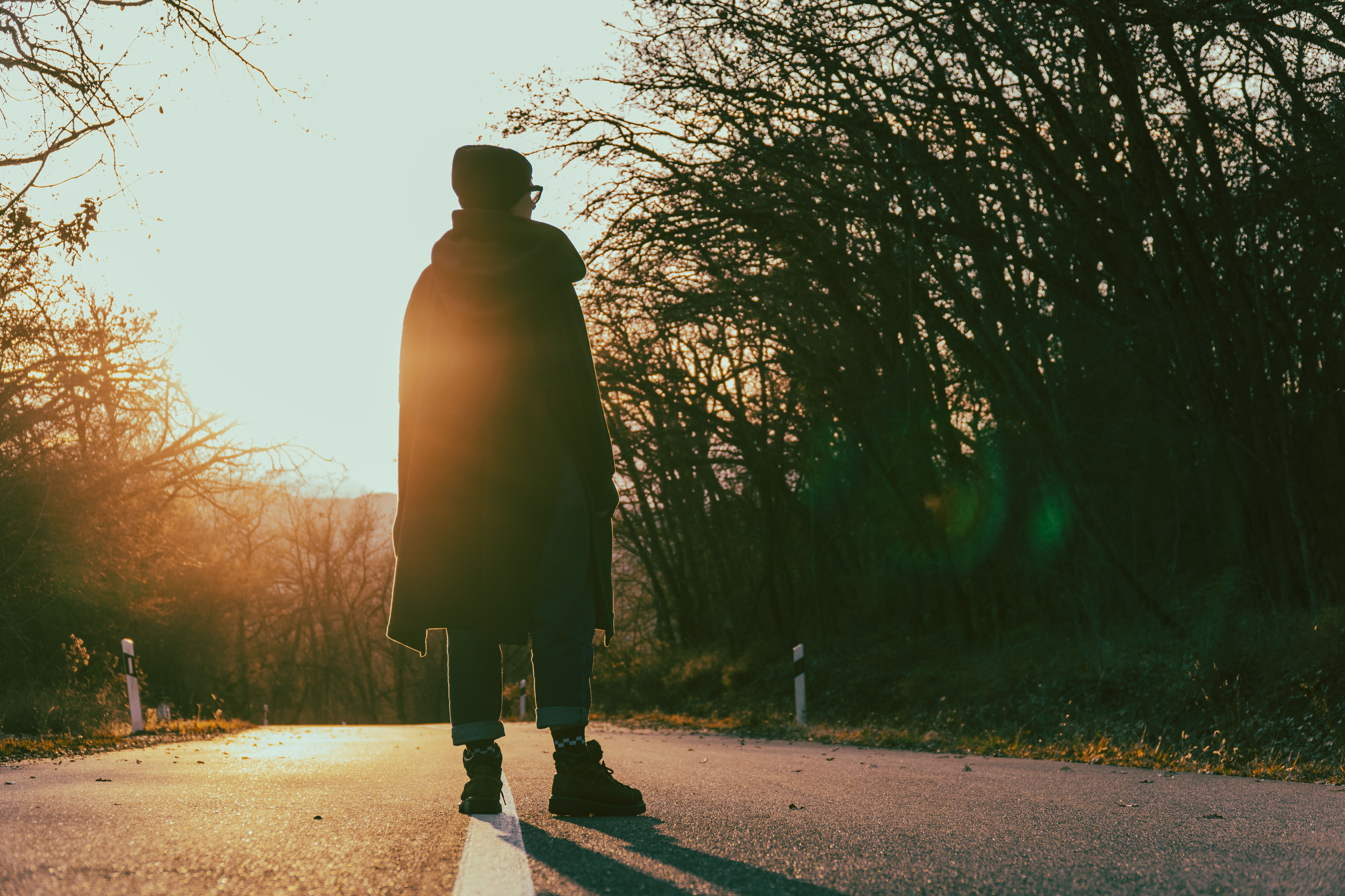 person walking in nature without phone, golden hour light