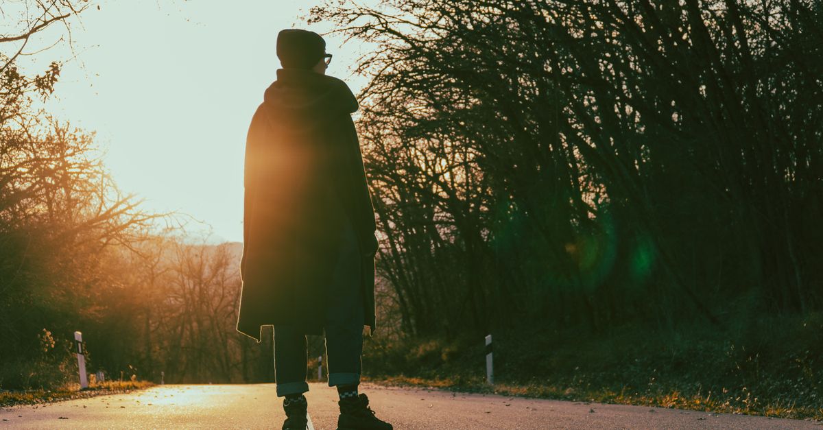 person walking in nature without phone, golden hour light