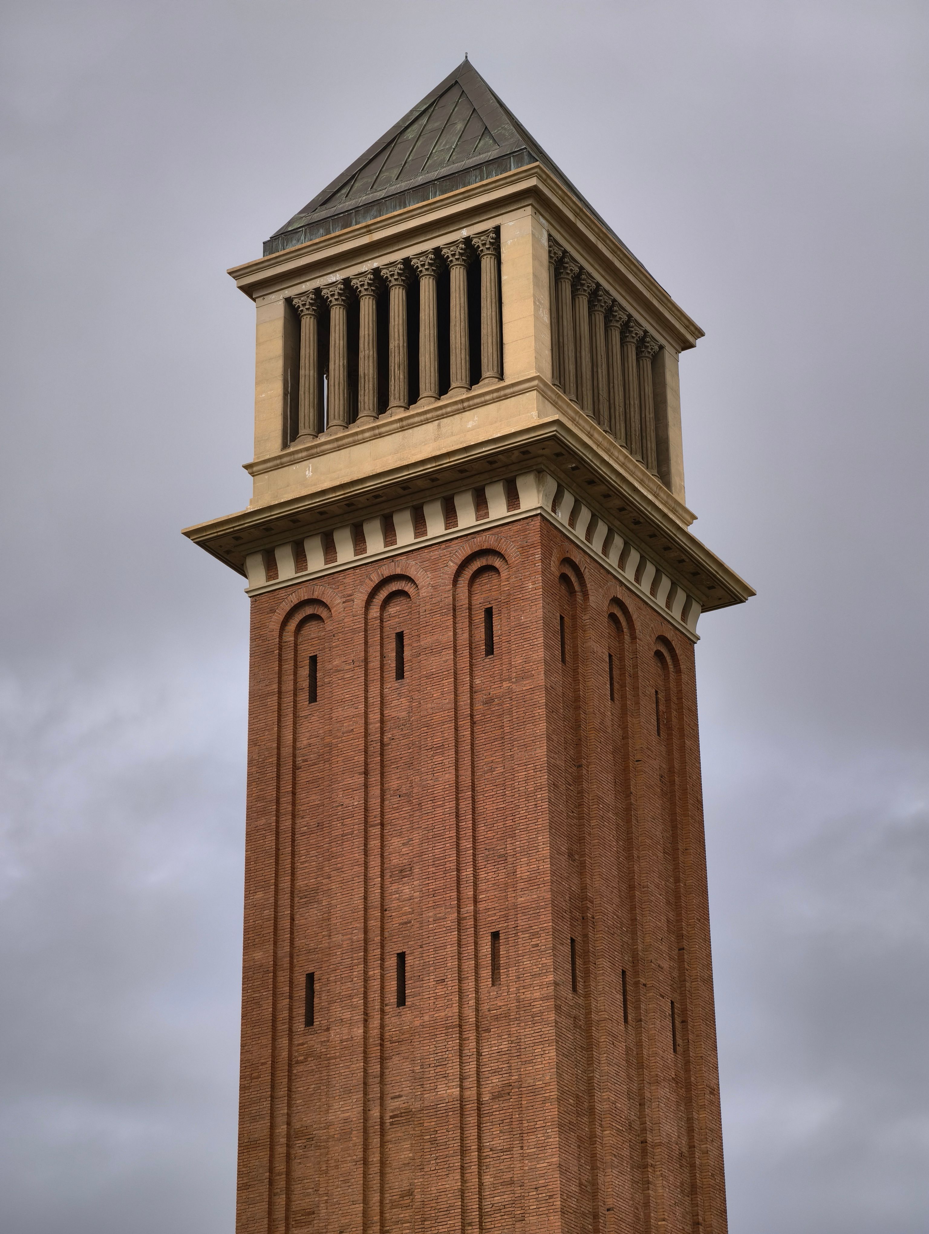 Majestic Brick Tower Against Cloudy Sky · Free Stock Photo