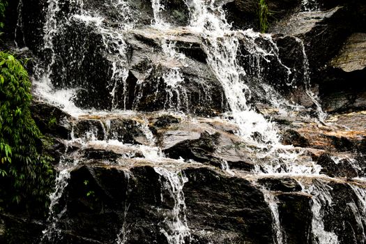 Stunning close-up of a cascading waterfall with lush greenery.