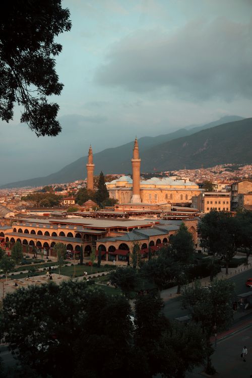 Free A breathtaking view of Bursa's Grand Mosque at sunset, showcasing its architectural beauty and natural surroundings. Stock Photo