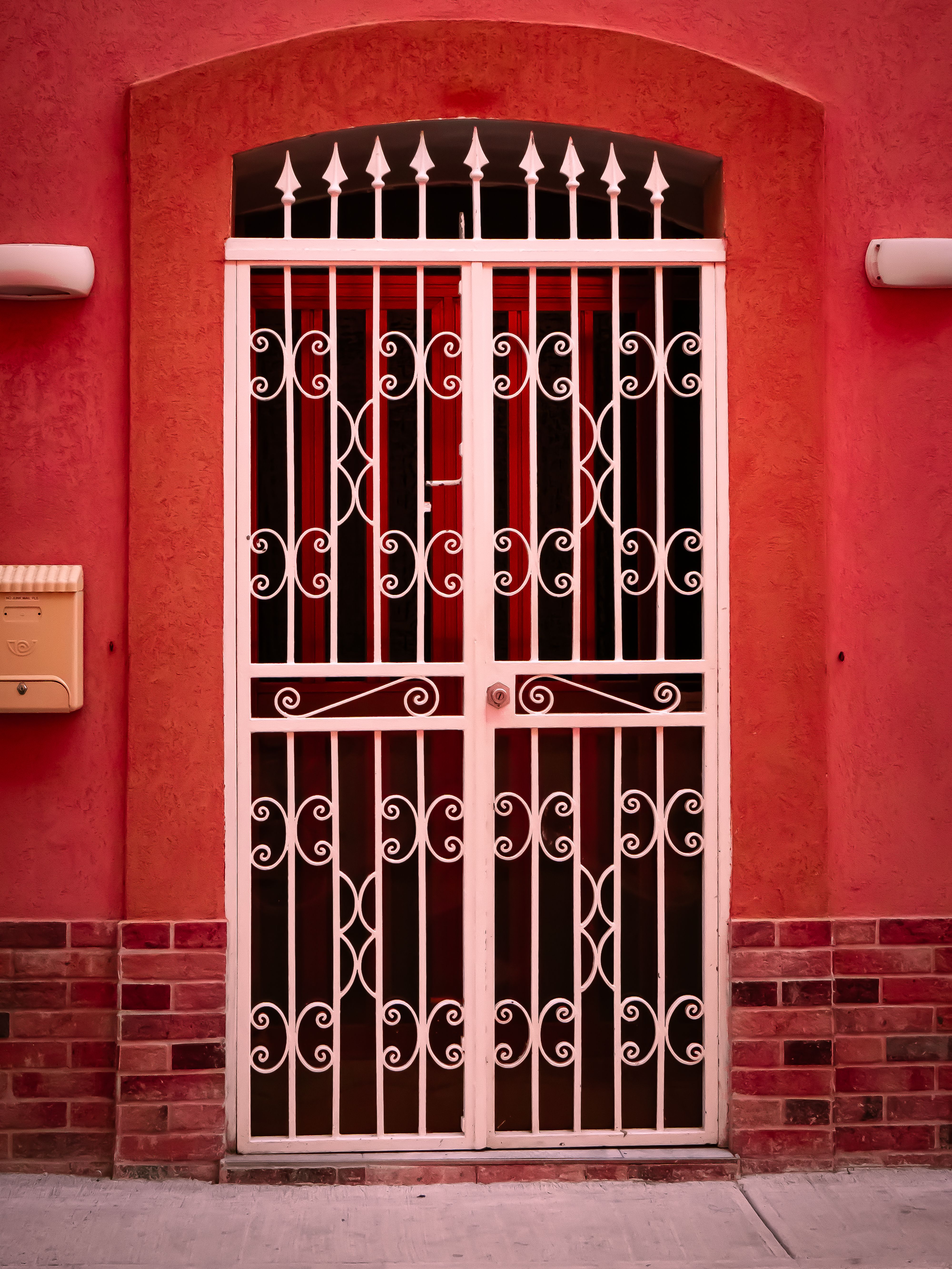 Rustic Red Facade & Iron Gate Entrance · Free Stock Photo