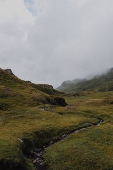Serene misty landscape of mountains and meadows in Grindelwald, Switzerland.