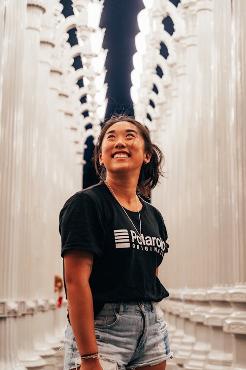 Woman Looking Upwards during Night