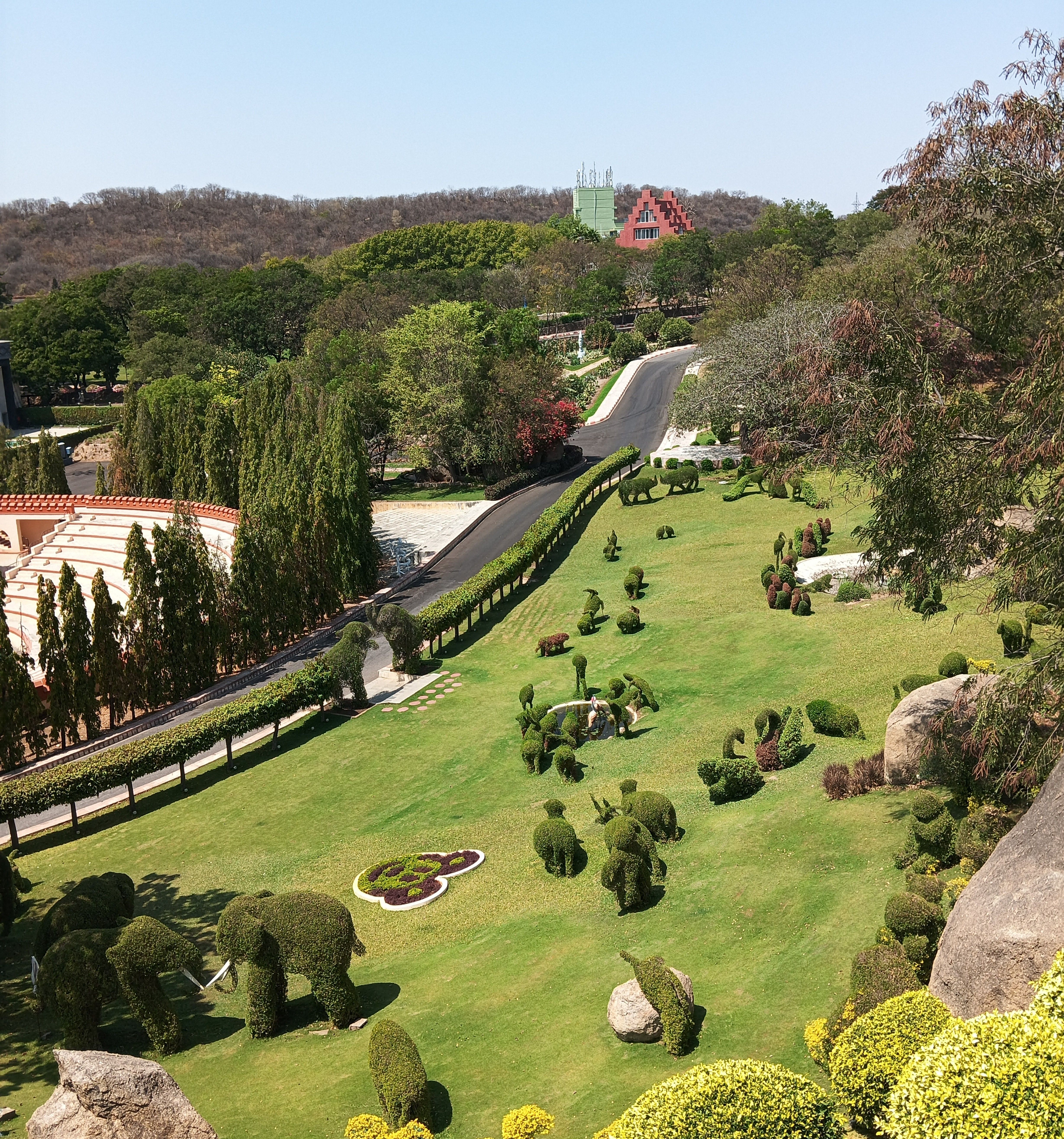 Aerial view of a landscaped garden with lush greenery and creative topiary art.