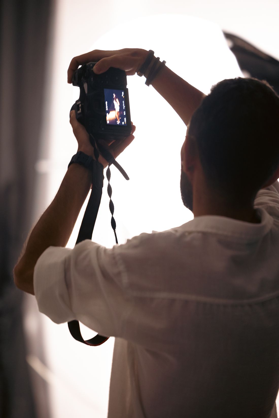 Photographer reviewing a shot on camera at Photo Pixel Park Studio