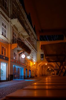 Charming illuminated street in Prešov, Slovakia under night sky with decorative lights.