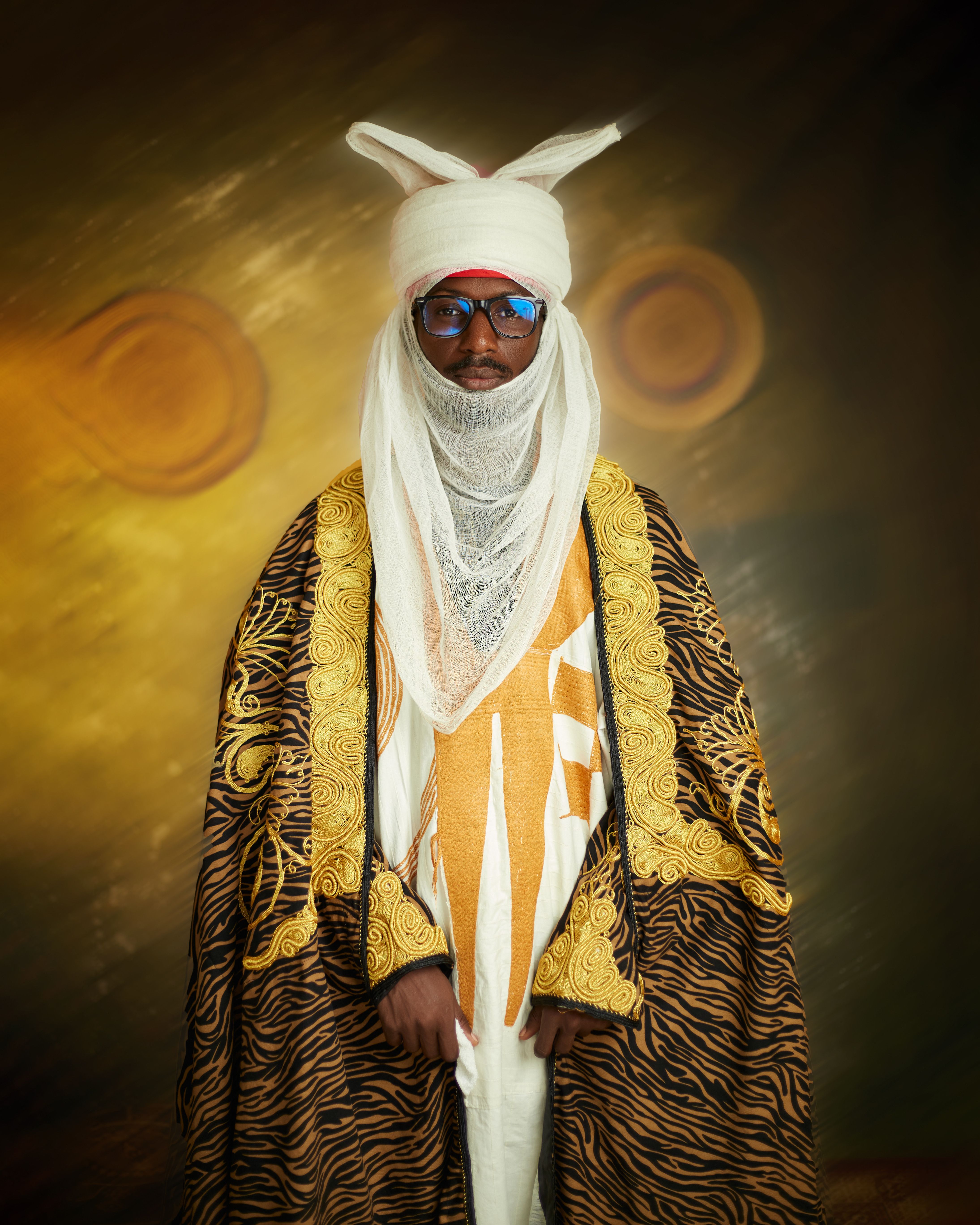 Man in elaborate traditional attire with turban, showing cultural richness.