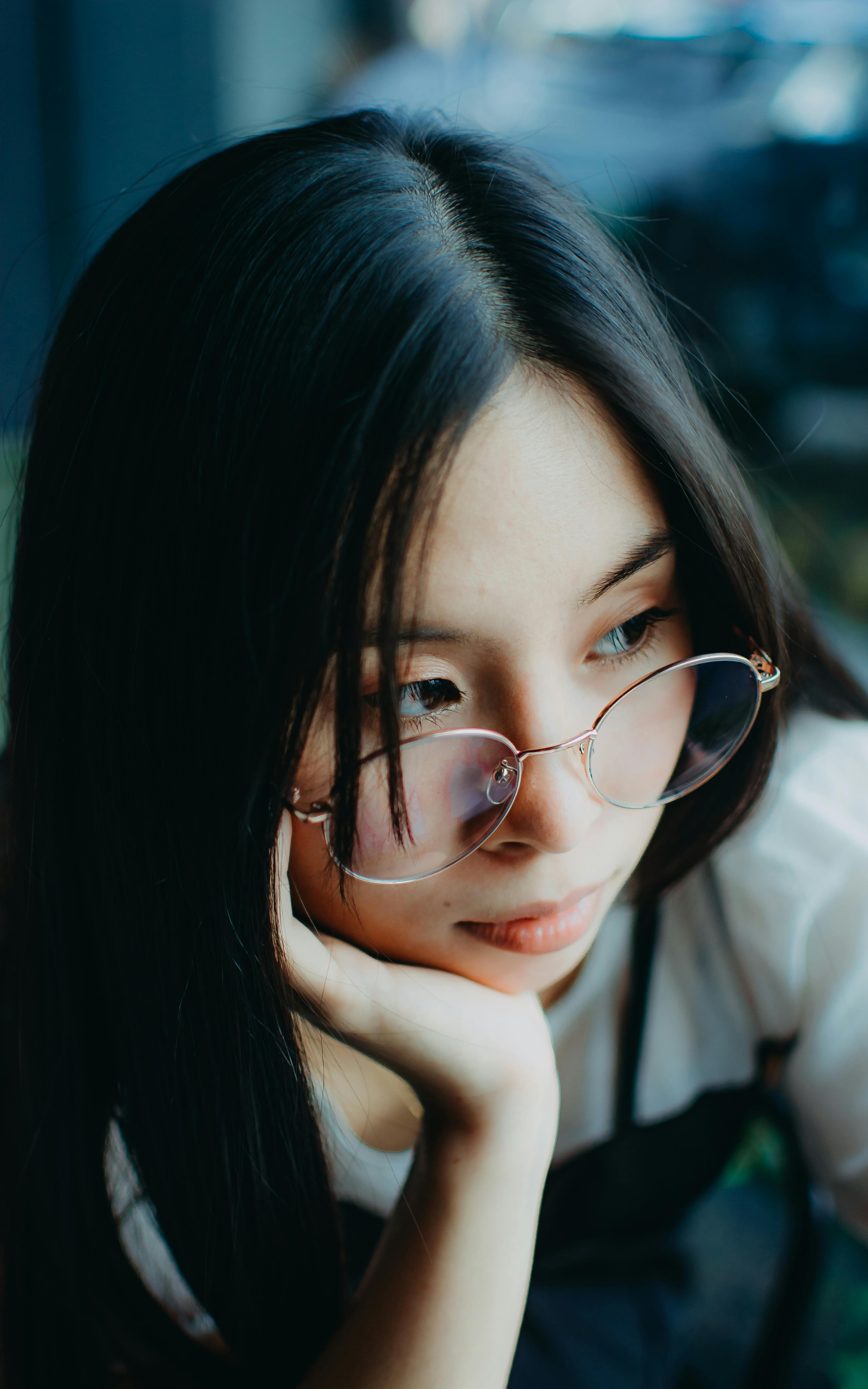 Pensive Woman in Glasses Looking Aside · Free Stock Photo
