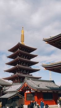 Explore the iconic five-story pagoda at Sensoji Temple in Asakusa, Tokyo, Japan under a clear sky.