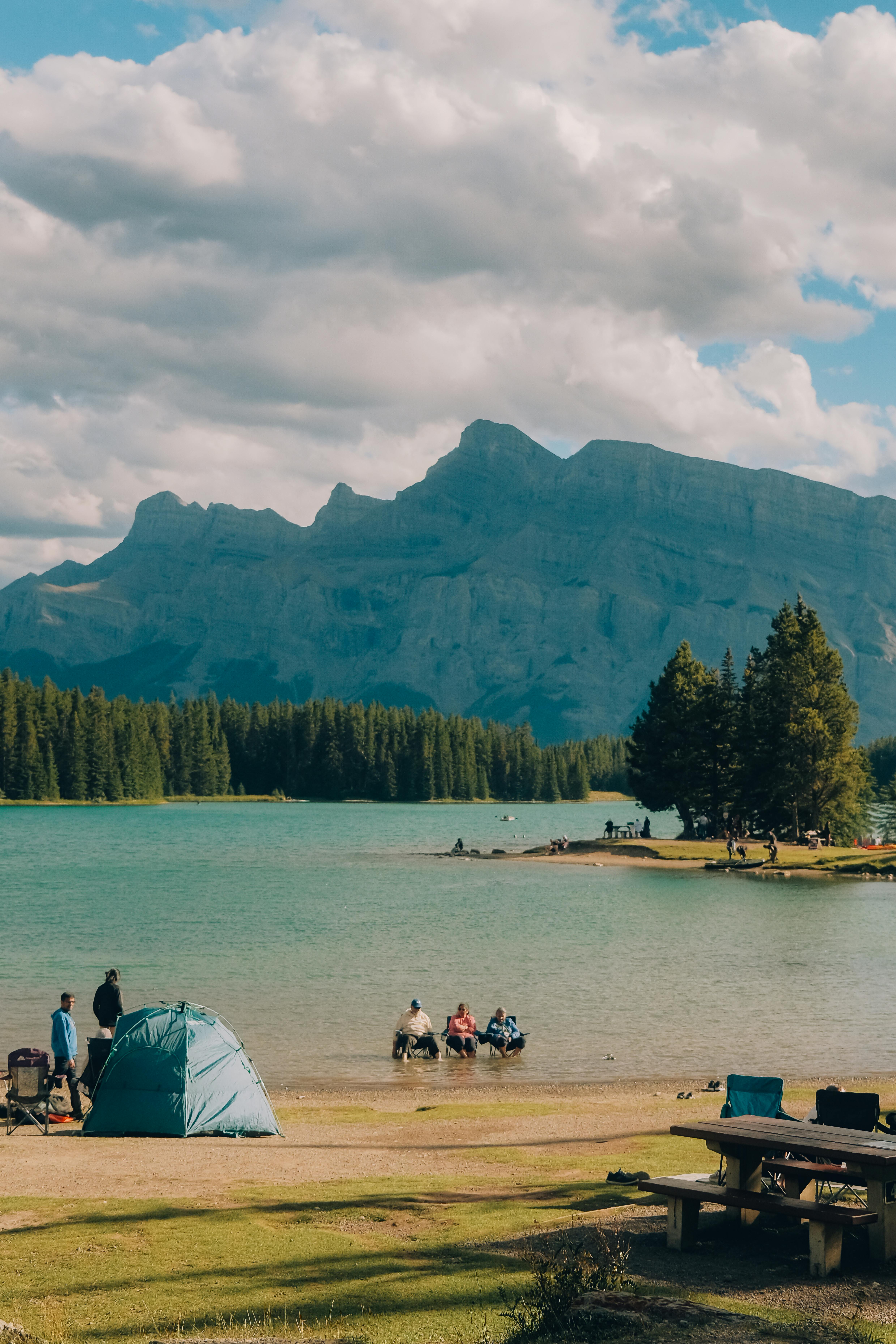 Experience the serene beauty of Banff National Park with camping by the lake and majestic mountain views.