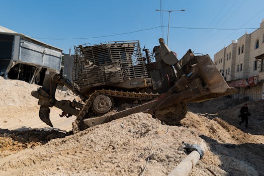A heavy bulldozer working on a construction site in an urban environment during daytime.