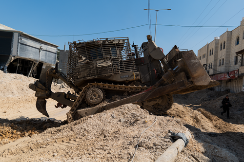 Free A heavy bulldozer working on a construction site in an urban environment during daytime. Stock Photo