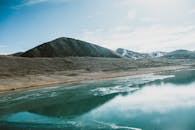 宁静的湖水映衬着山景，天空晴朗