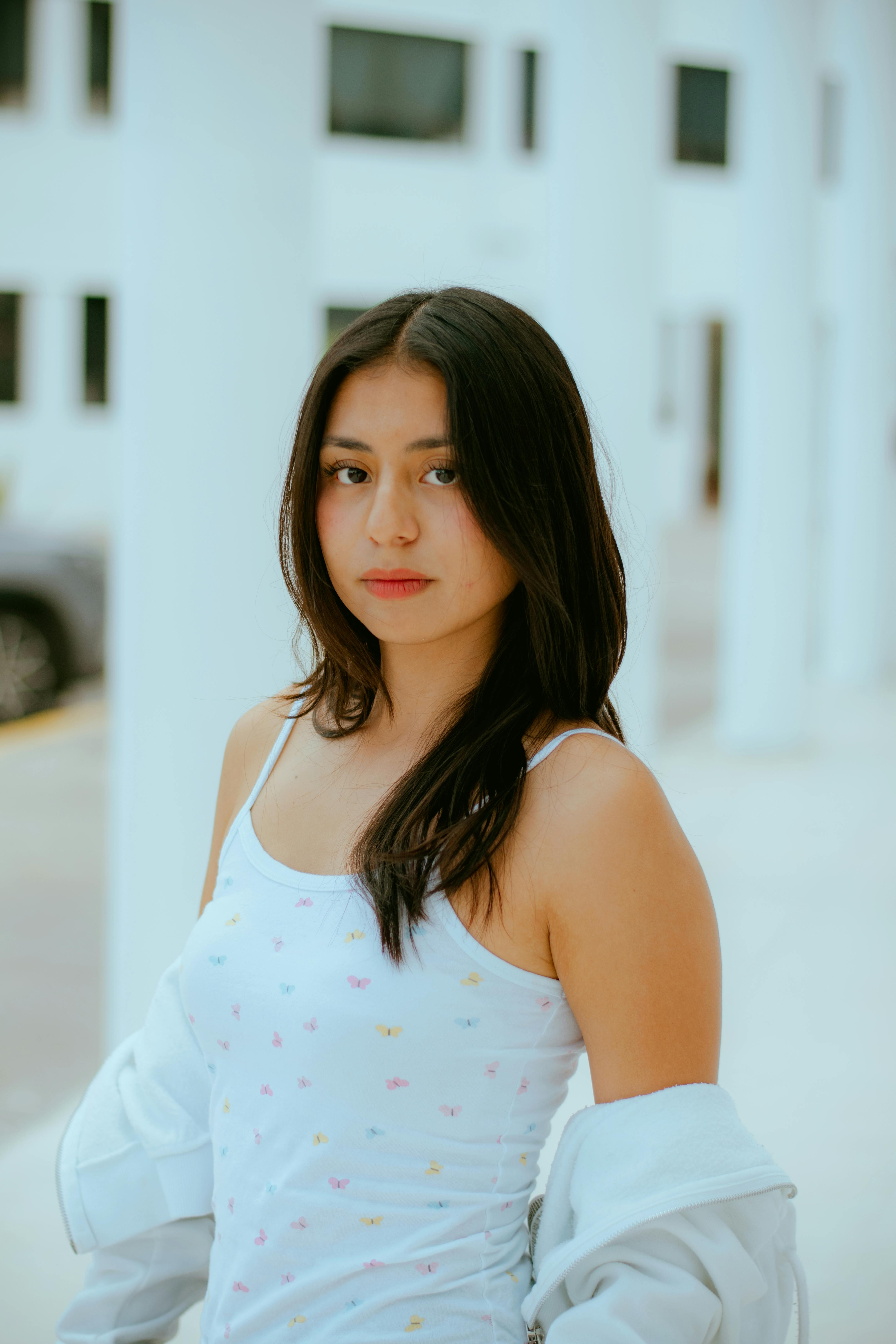 A young woman poses confidently in an urban setting in Puebla, Mexico.