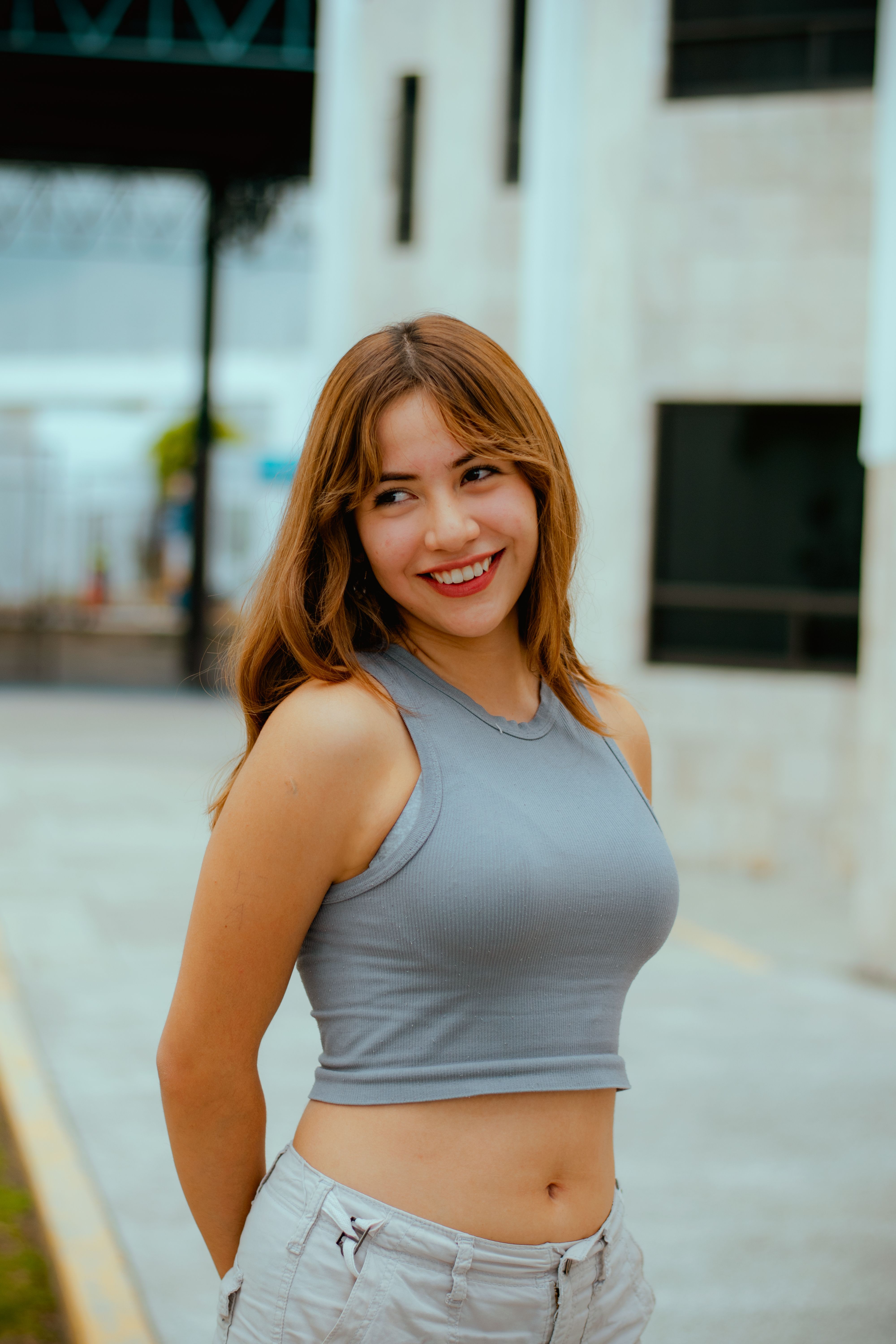A young woman smiling confidently while posing outdoors in Puebla, Mexico.