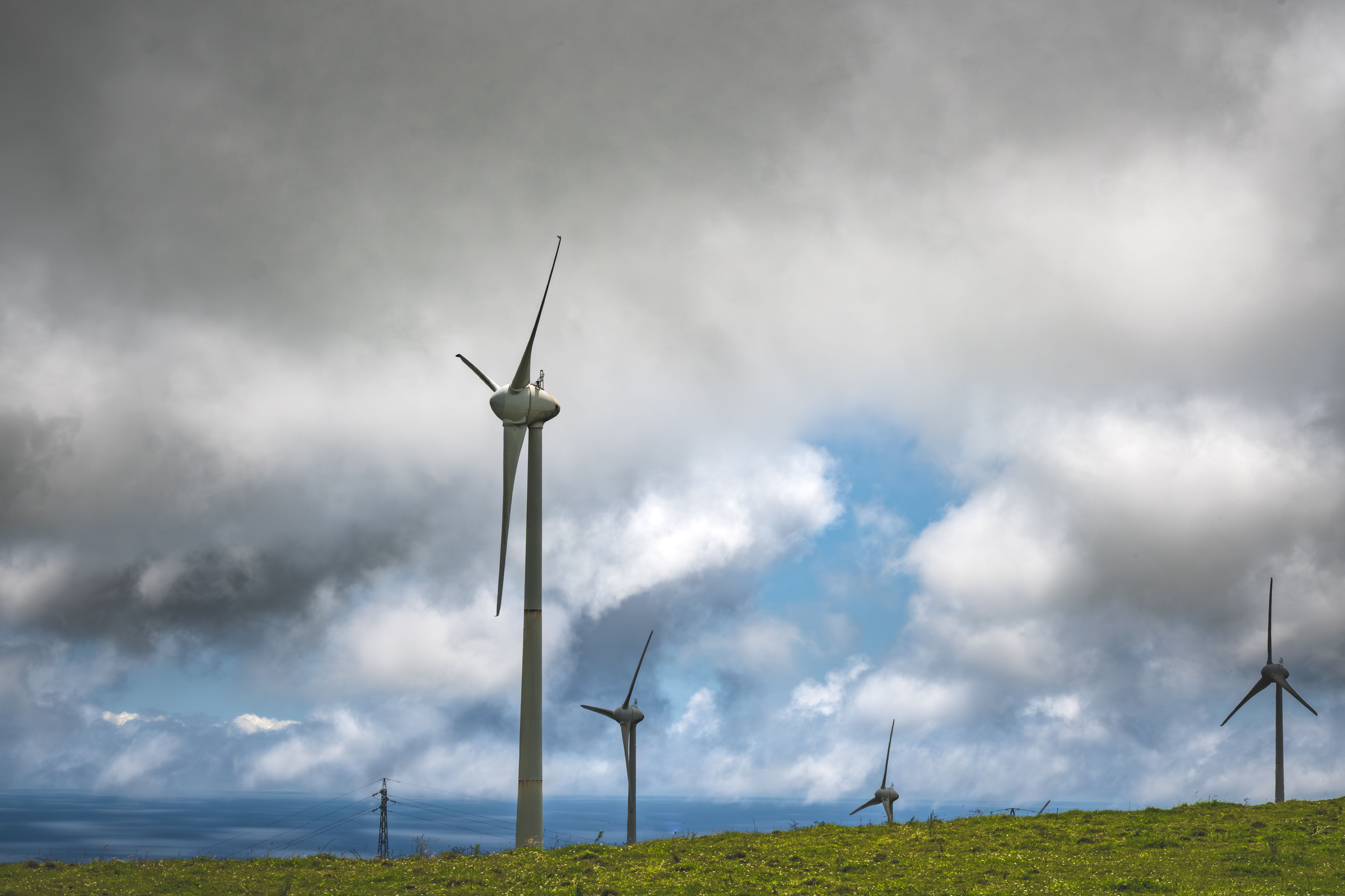 Wind Turbines Under Cloudy Sky in Open Field · Free Stock Photo