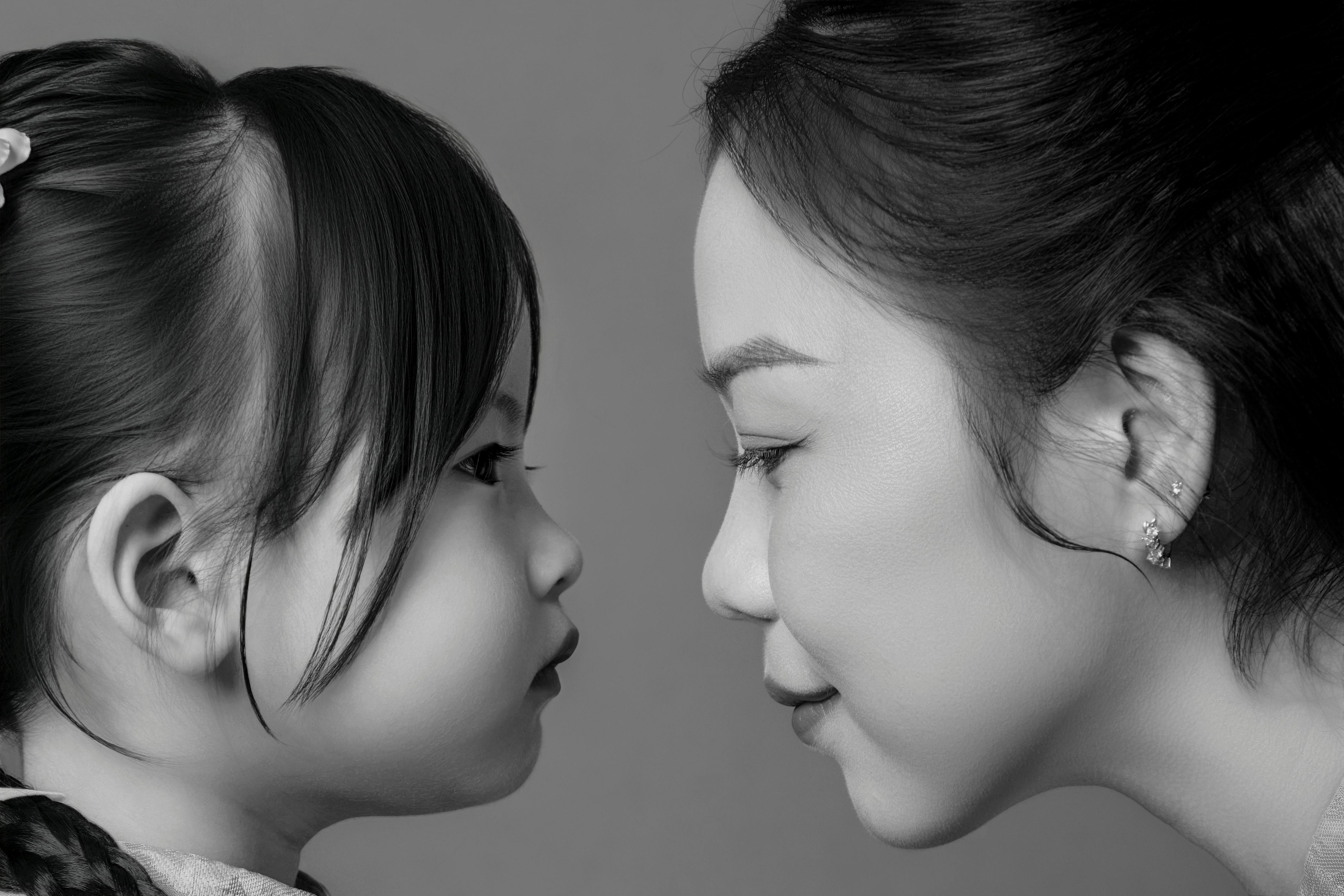 Intimate black and white portrait capturing the bond between mother and child.