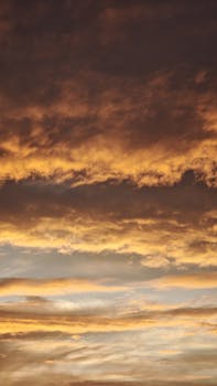 Captivating sunset sky filled with vibrant golden clouds and a calming atmosphere.