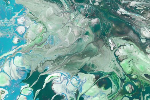 Vivid abstract fluid art with swirling green and blue patterns creating a dynamic visual effect.