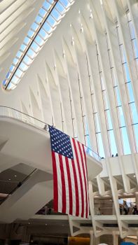 Interior view of the Oculus with an American flag hanging prominently in New York City.