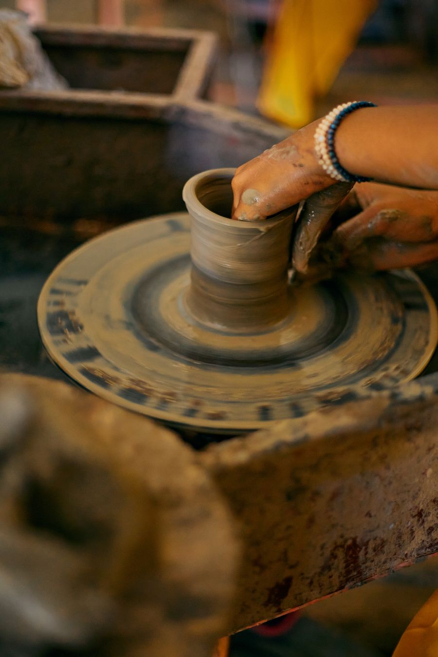 A potter shaping a bowl on a wheel, photo by Finalchoice on Pexels