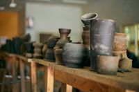 Rustic pottery on a wooden shelf, photo by Finalchoice on Pexels