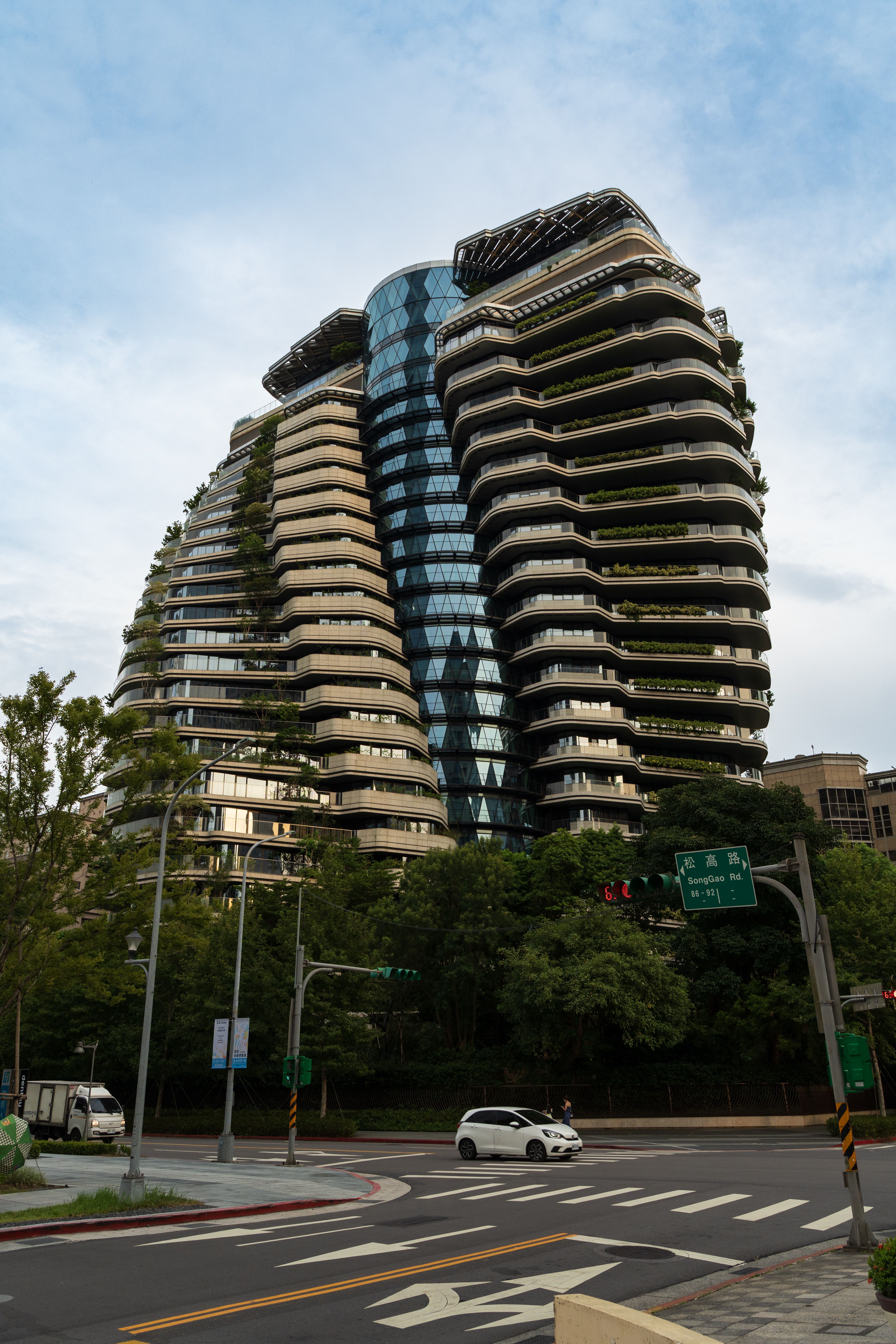 Modern architecture with green design elements in a cityscape setting.