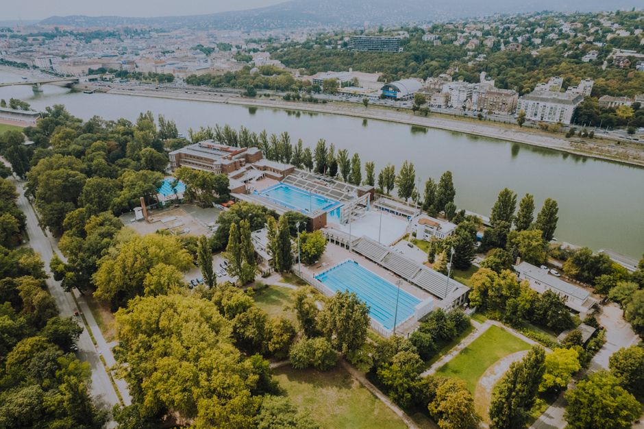 People enjoying the outdoor pools at Széchenyi Thermal Bath in Budapest, Hungary