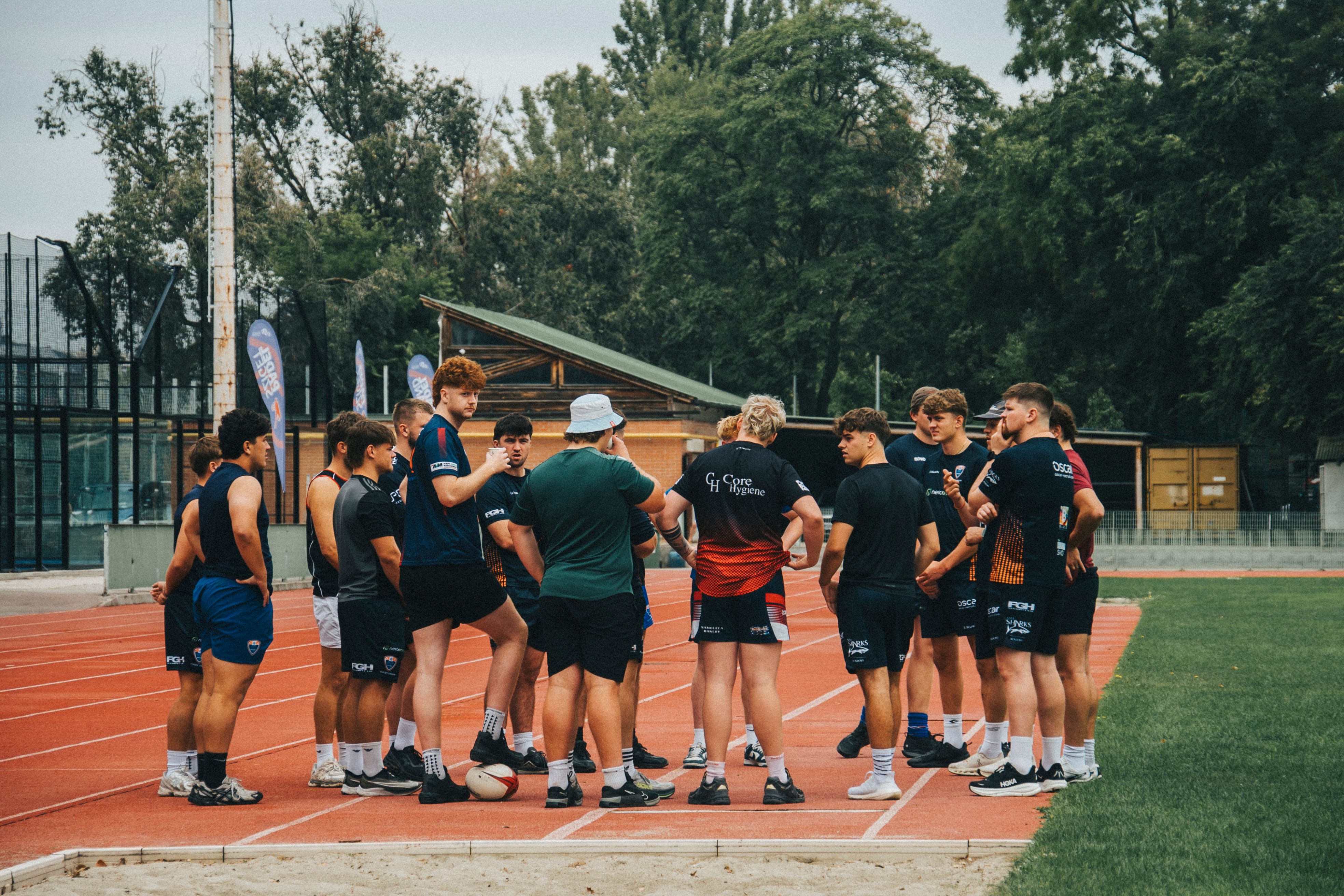 Team Huddle on Running Track Field · Free Stock Photo