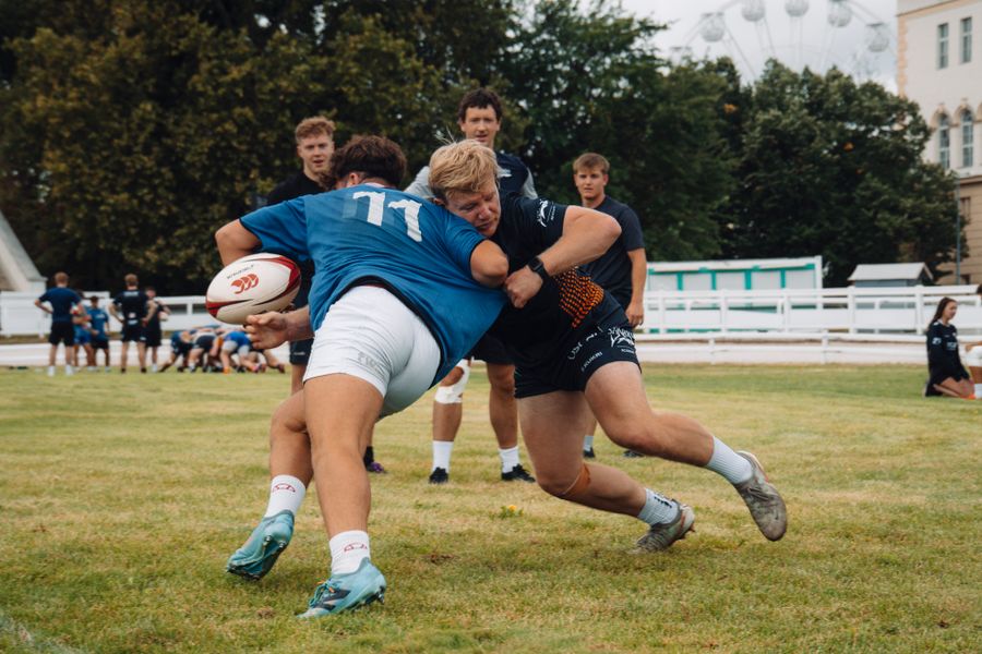 Rugby players practising contact and tackling
