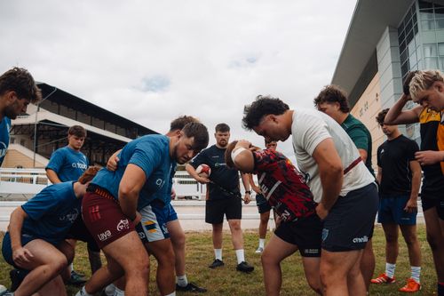 Free Outdoor rugby team training in Budapest with players practicing scrum alignment. Stock Photo