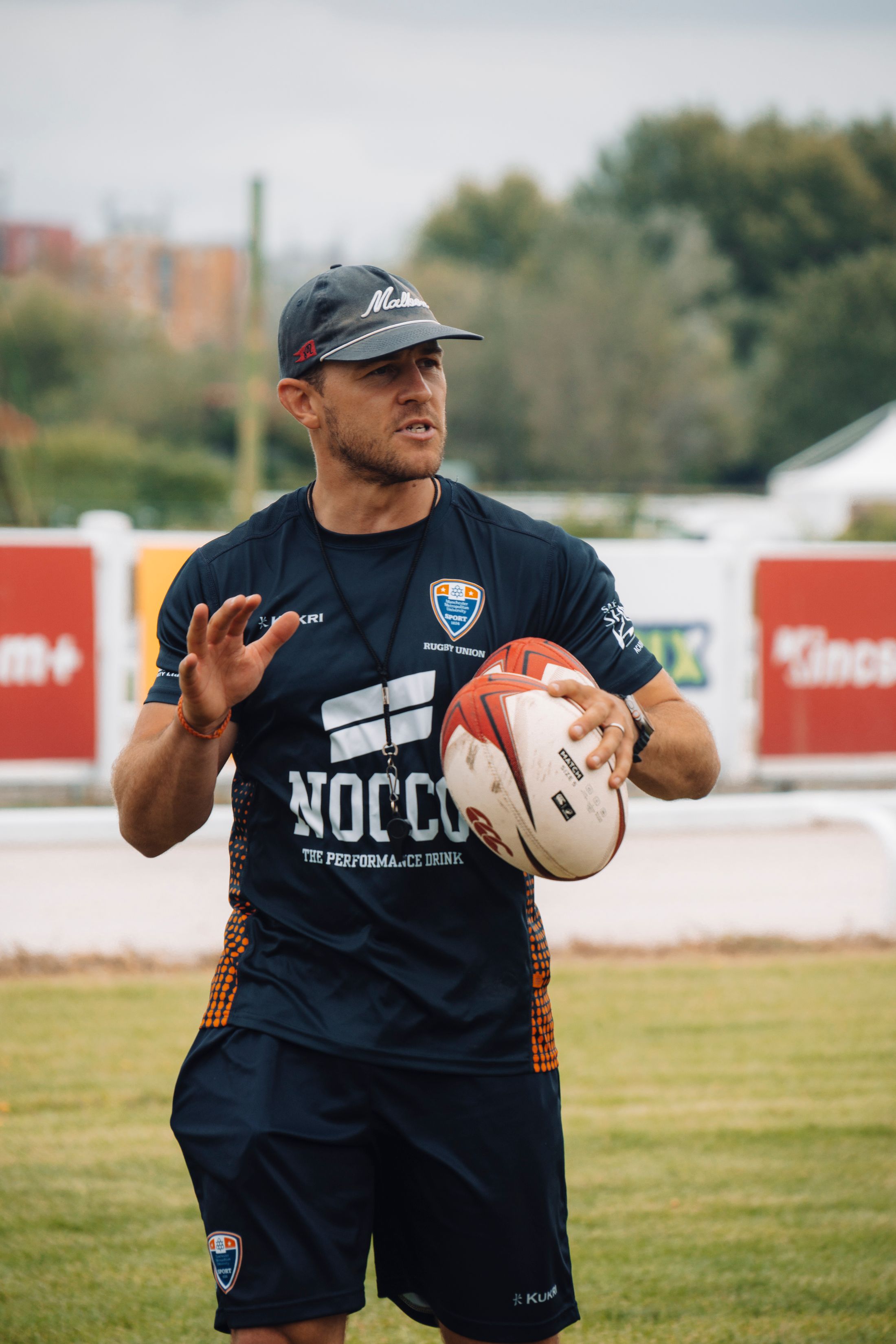 Rugby coach leading an outdoor training session