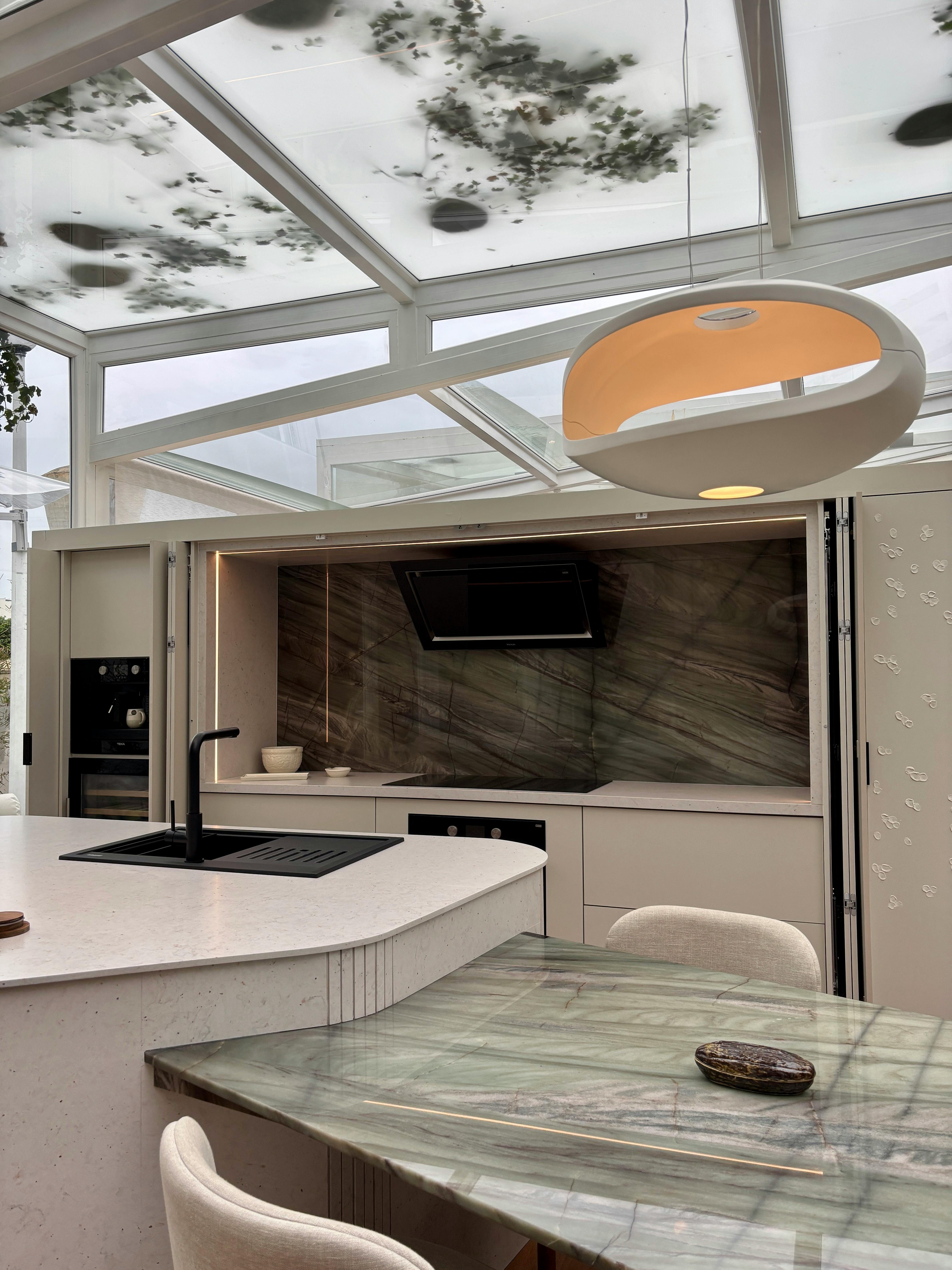Outdoor entertainment pavilion with integrated dining and cooking areas
