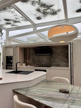 Sleek and contemporary kitchen featuring a glowing pendant light and skylight in Lima, Perú.