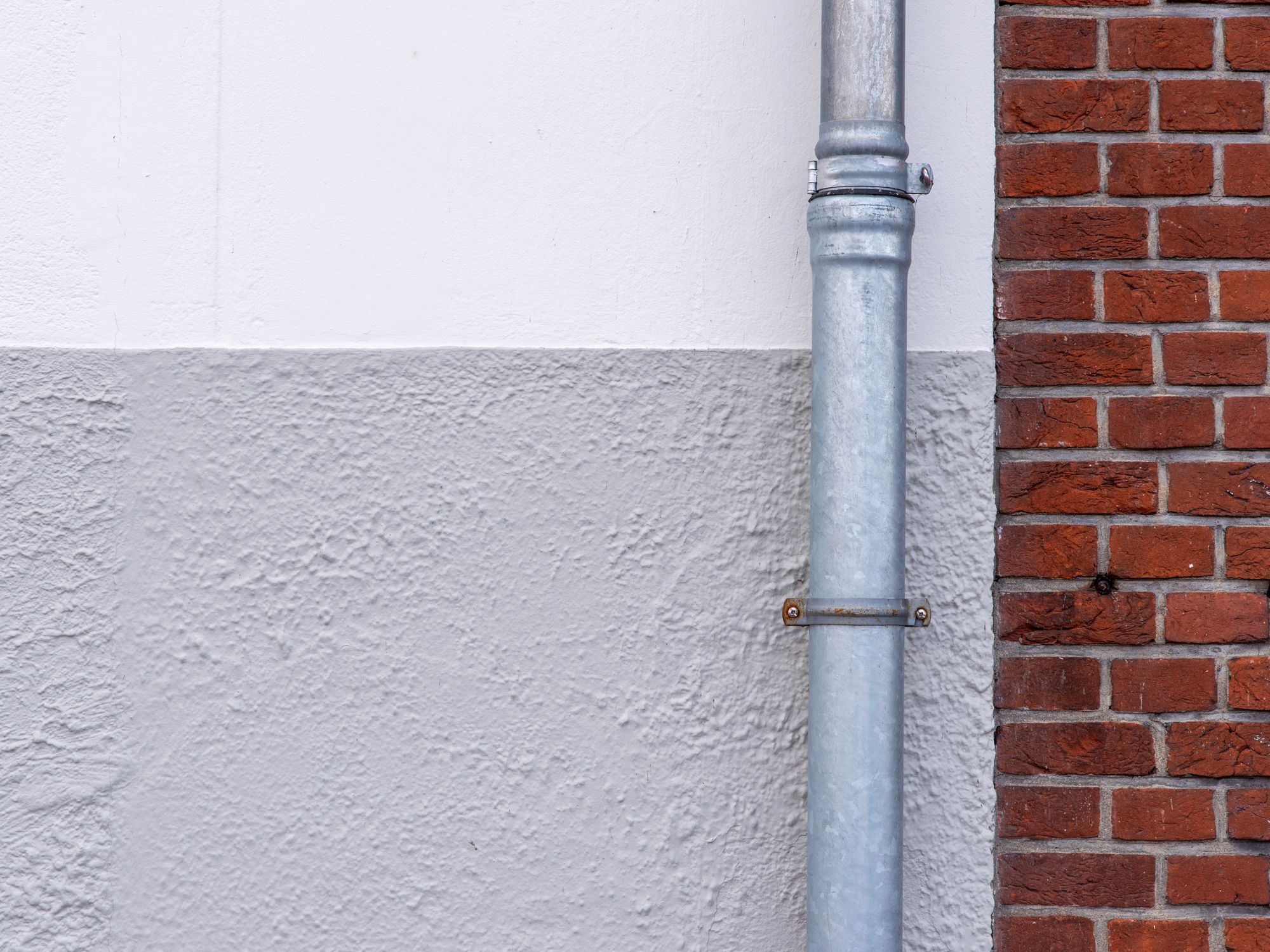 Painters & Decorators in Hatch End, London — professional decorator painting a wall with a roller
